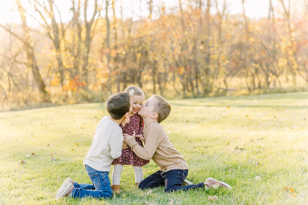Three children playing during their fall family session in Southern Minnesota.
