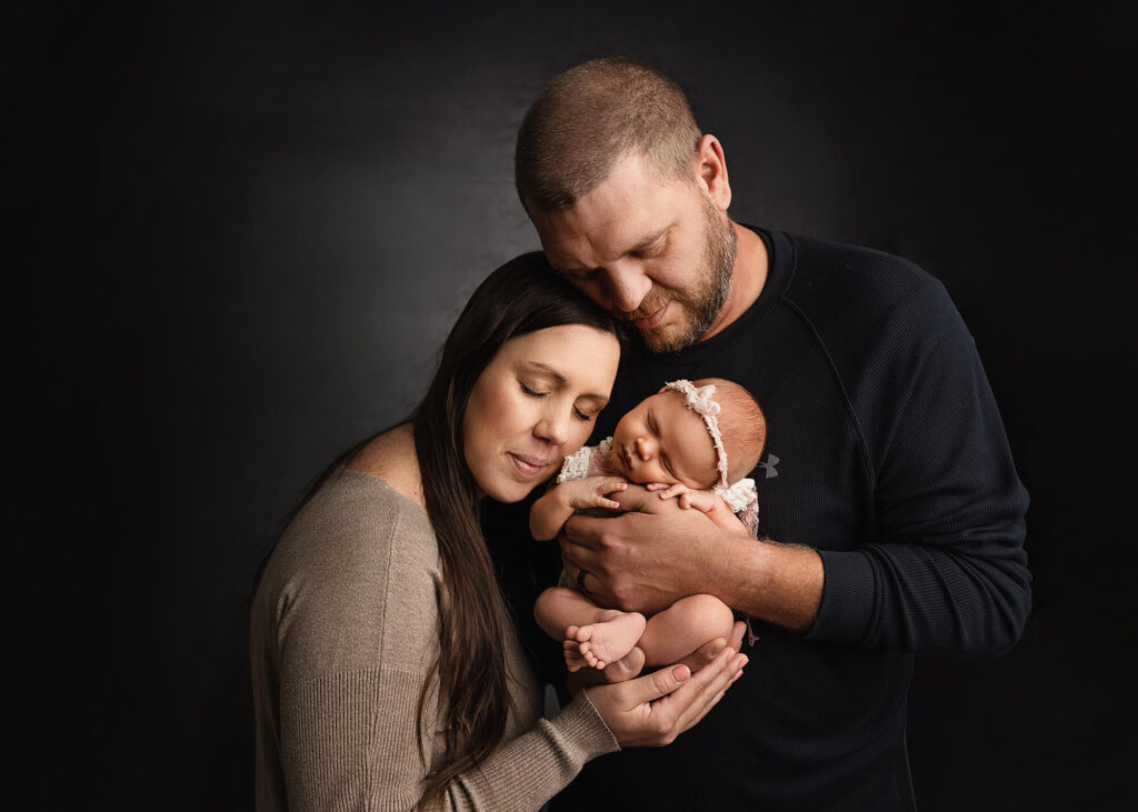 Posed parents with their newborn baby girl.