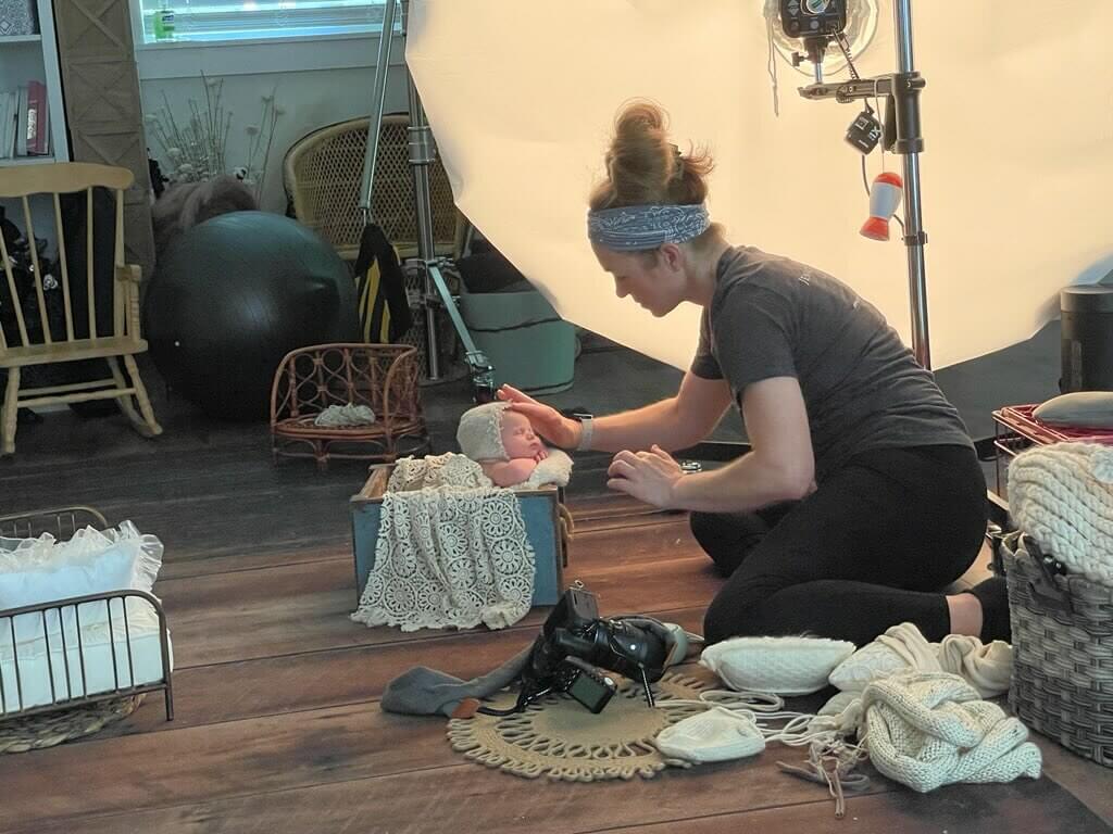 Soothing a newborn baby during a newborn photography session