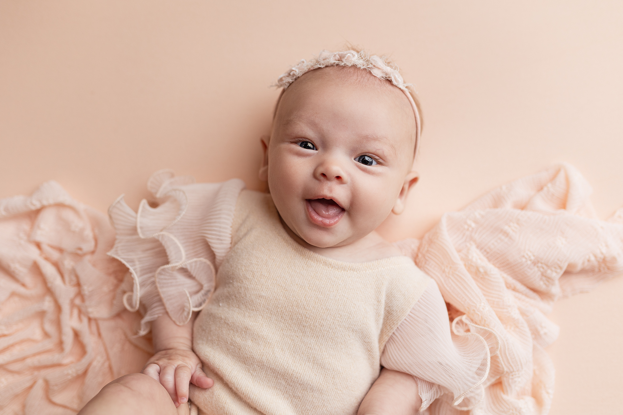 3-month milestone session capturing baby's first real smiles.