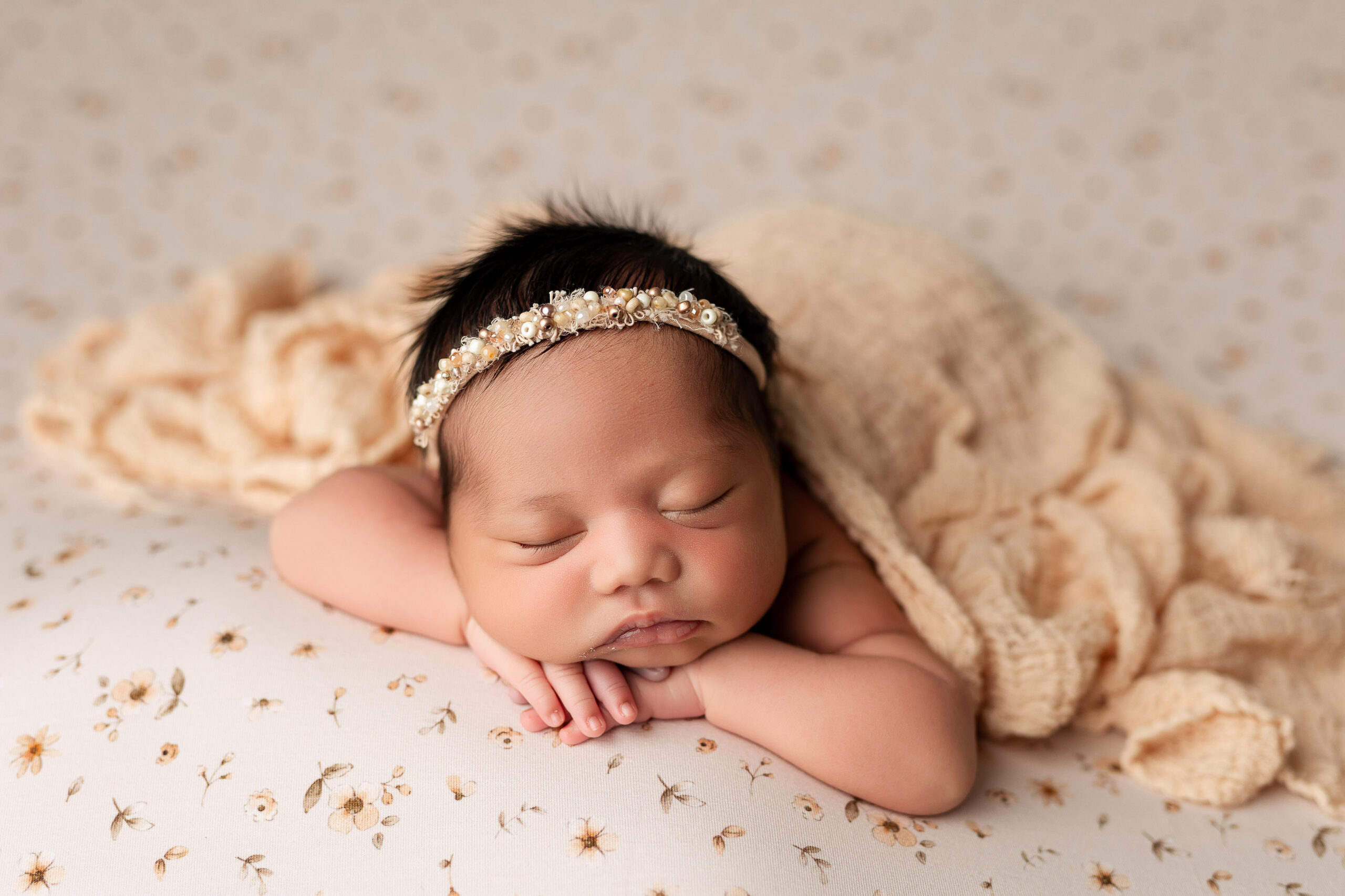 Head on hands pose with sleeping baby - safety-first newborn photographer.