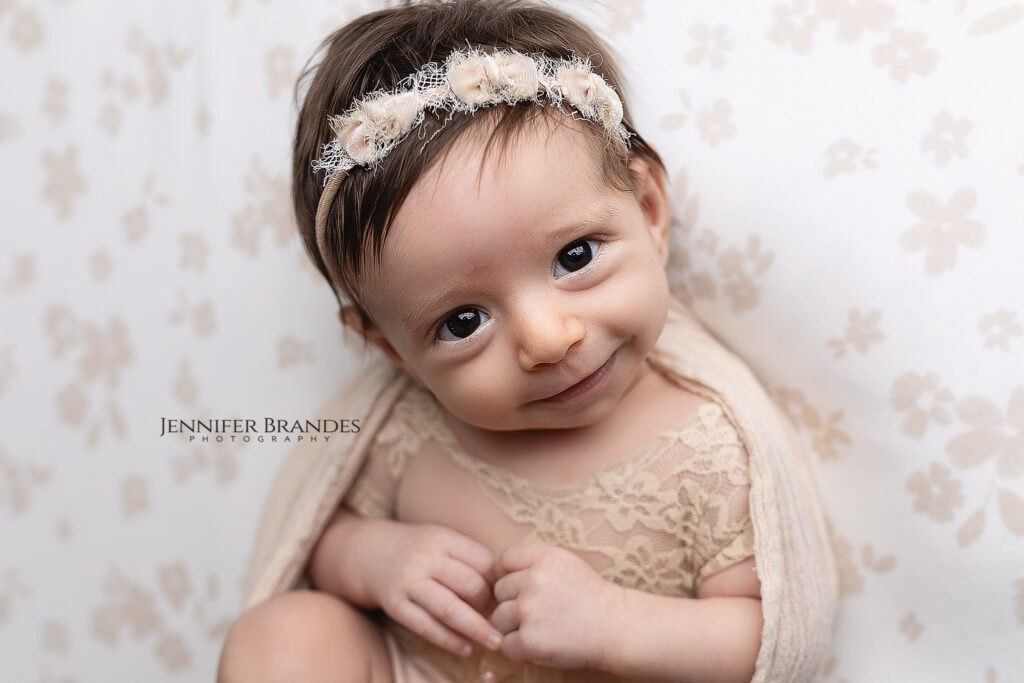 Older newborn sweetly smiling at the camera in New Ulm, Minnesota.