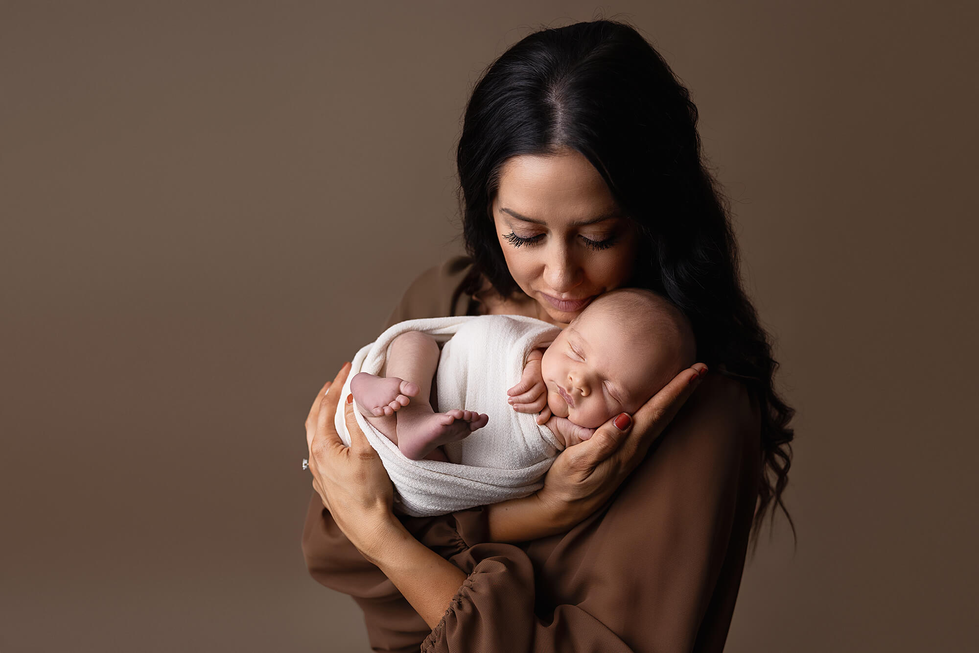 New mother holds her newborn during a studio session at Jennifer Brandes Photography — serving Mankato, New Ulm, Shakopee, Jordan, and South Central Minnesota families.