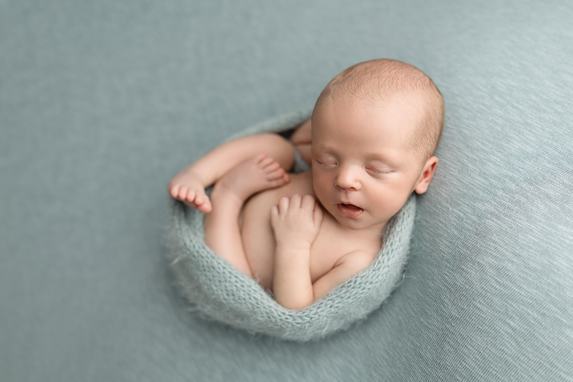 Newborn baby in a safe, gentle pose during a studio session with Jennifer Brandes Photography — safety-trained newborn photographer serving Mankato, New Ulm, and South Central Minnesota.